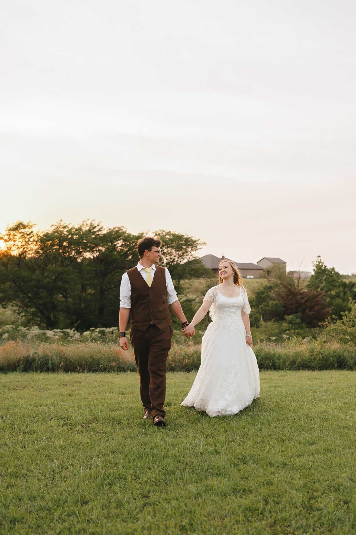 Charity and Matthew walking together after their wedding ceremony